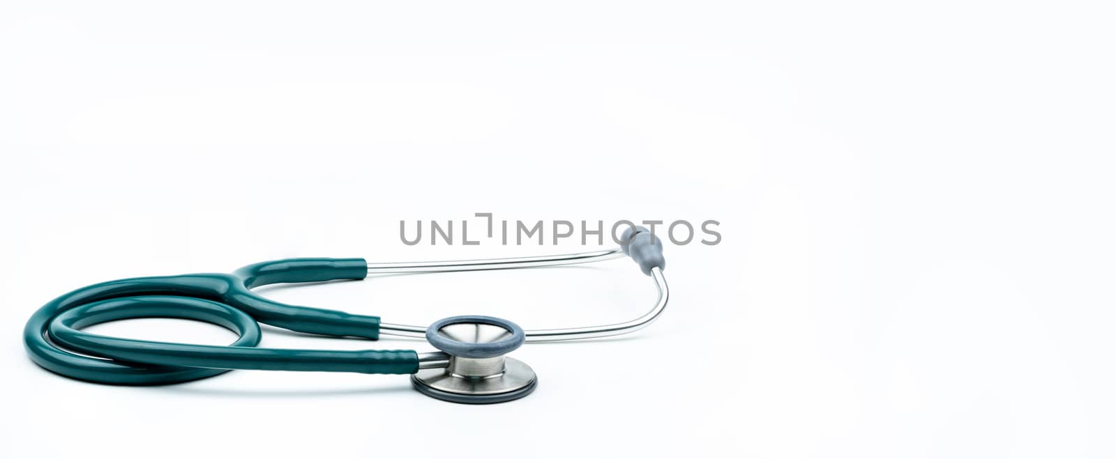 Green stethoscope isolated on white background with copy space. Medical tool for doctor. Health check up concept. Medical equipment for listen heart beat. Clinical Cardiology concept.