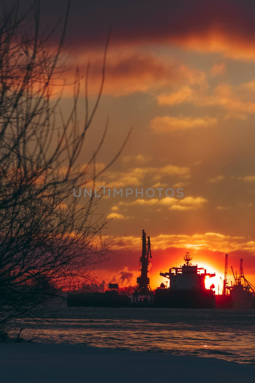 Colorful winter sunrise against the cargo port