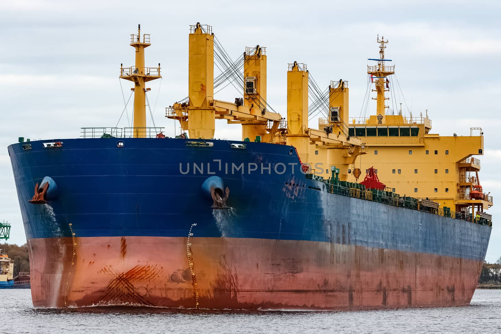 Blue cargo ship entering the port of Riga, Europe