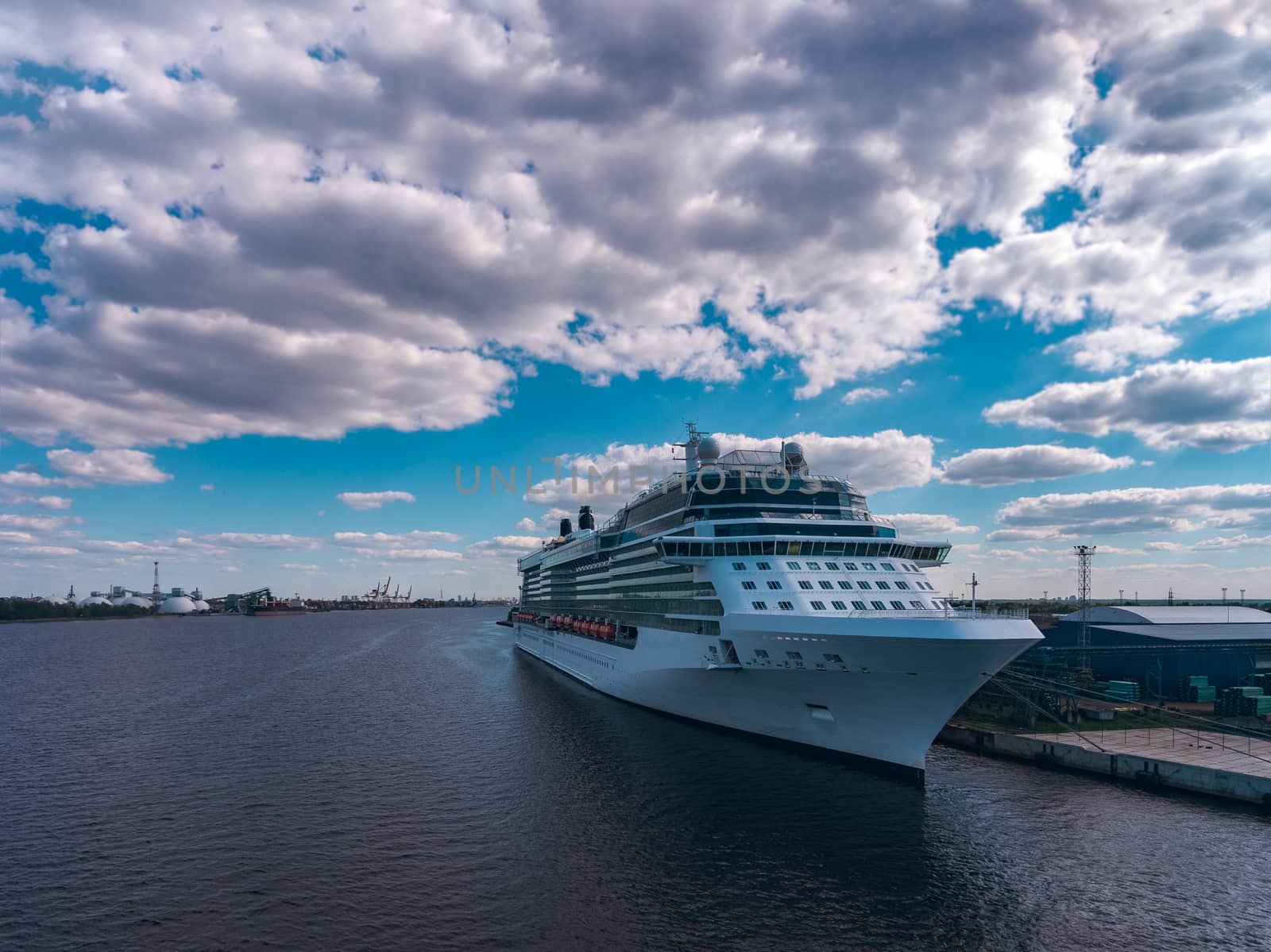 Big white passenger ship moored at the cargo port