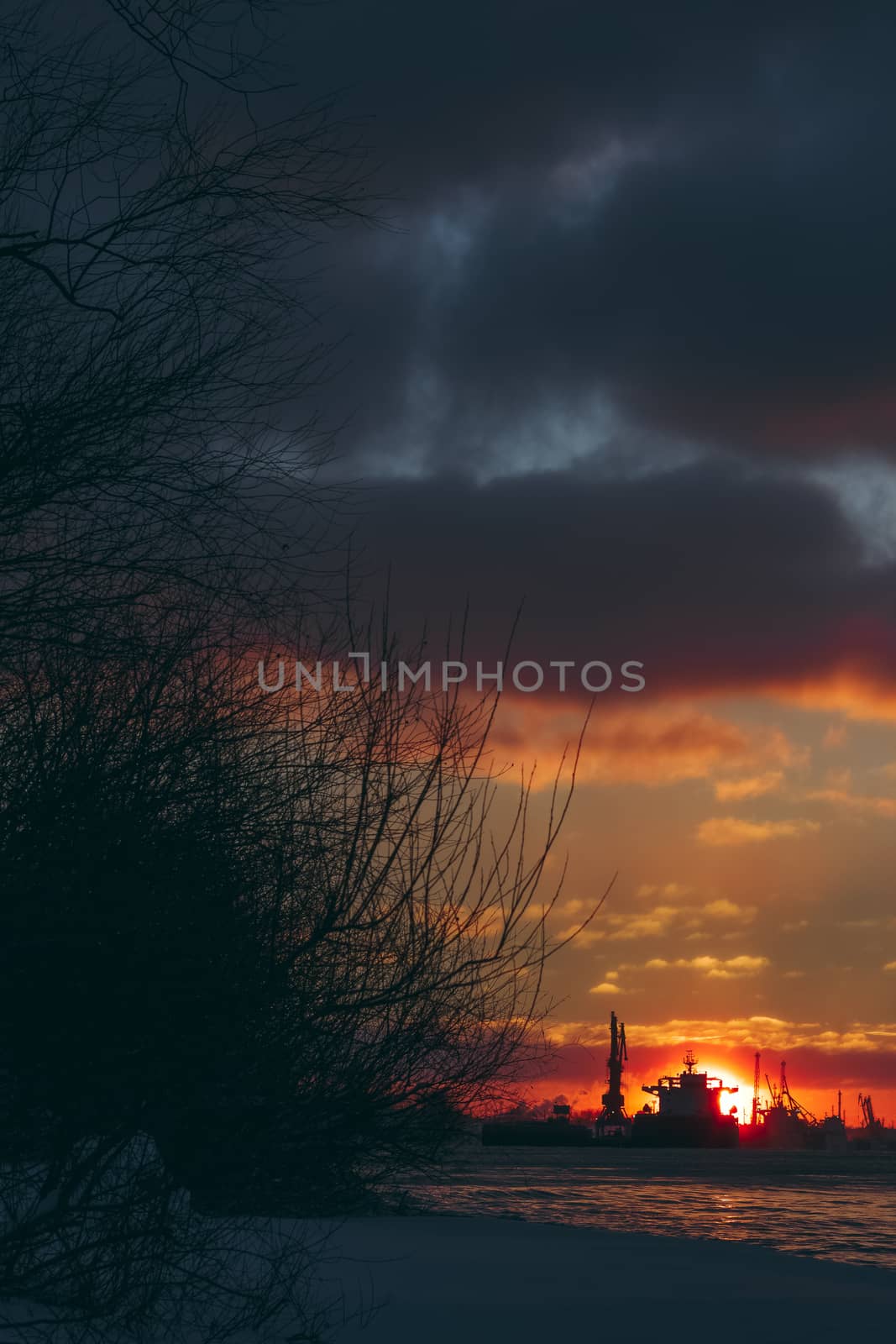 Colorful winter sunrise against the cargo port