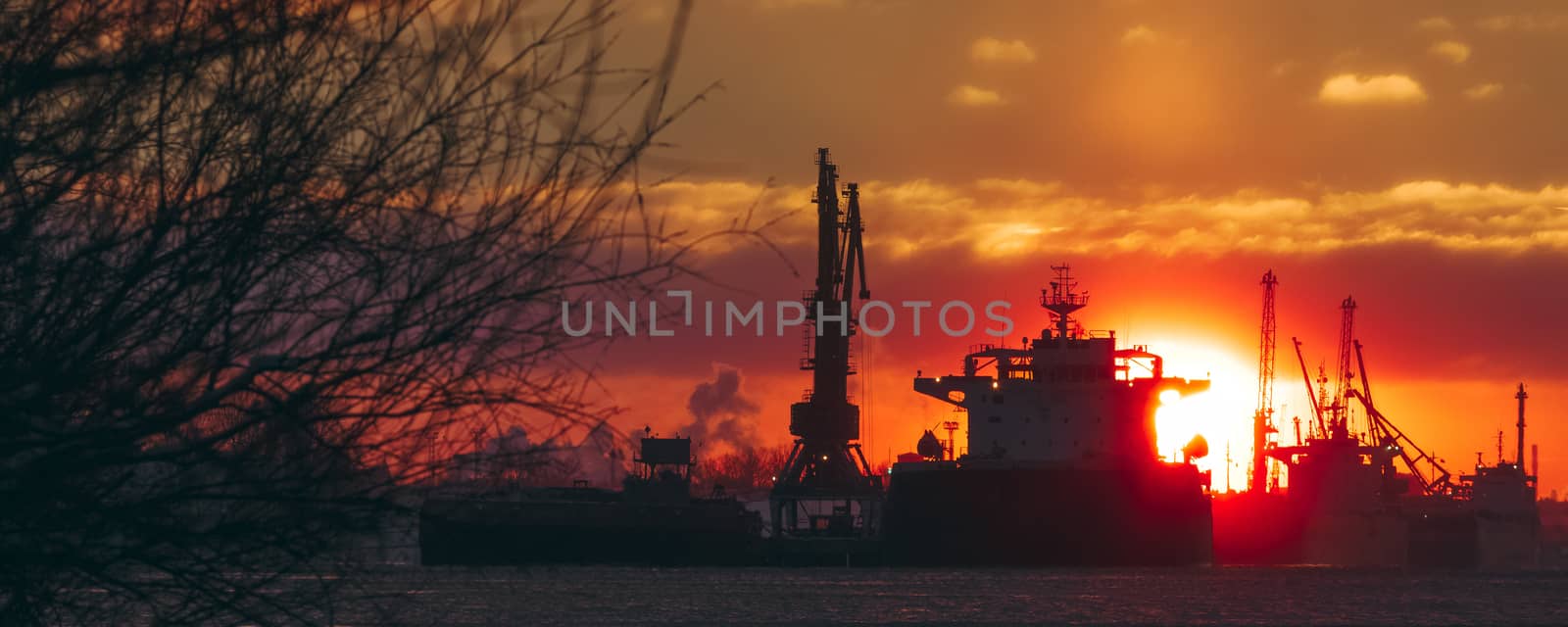 Colorful winter sunrise against the cargo port