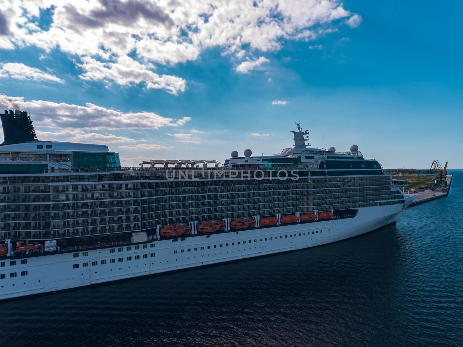 Big white passenger ship moored at the cargo port
