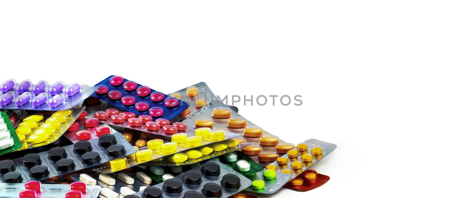 Pile of tablet pills isolated on white background. Yellow, purple, black, orange,  pink , green tablet pills in blister pack. Painkiller medicine. Drug for migraine headache. Pharmaceutical industry.