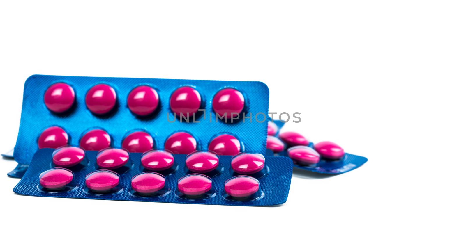 Ibuprofen in pink tablet pills pack in blue blister pack isolated on white background with copy space. Ibuprofen for relief pain, headache, high fever and anti-inflammatory. Painkiller tablets pills.
