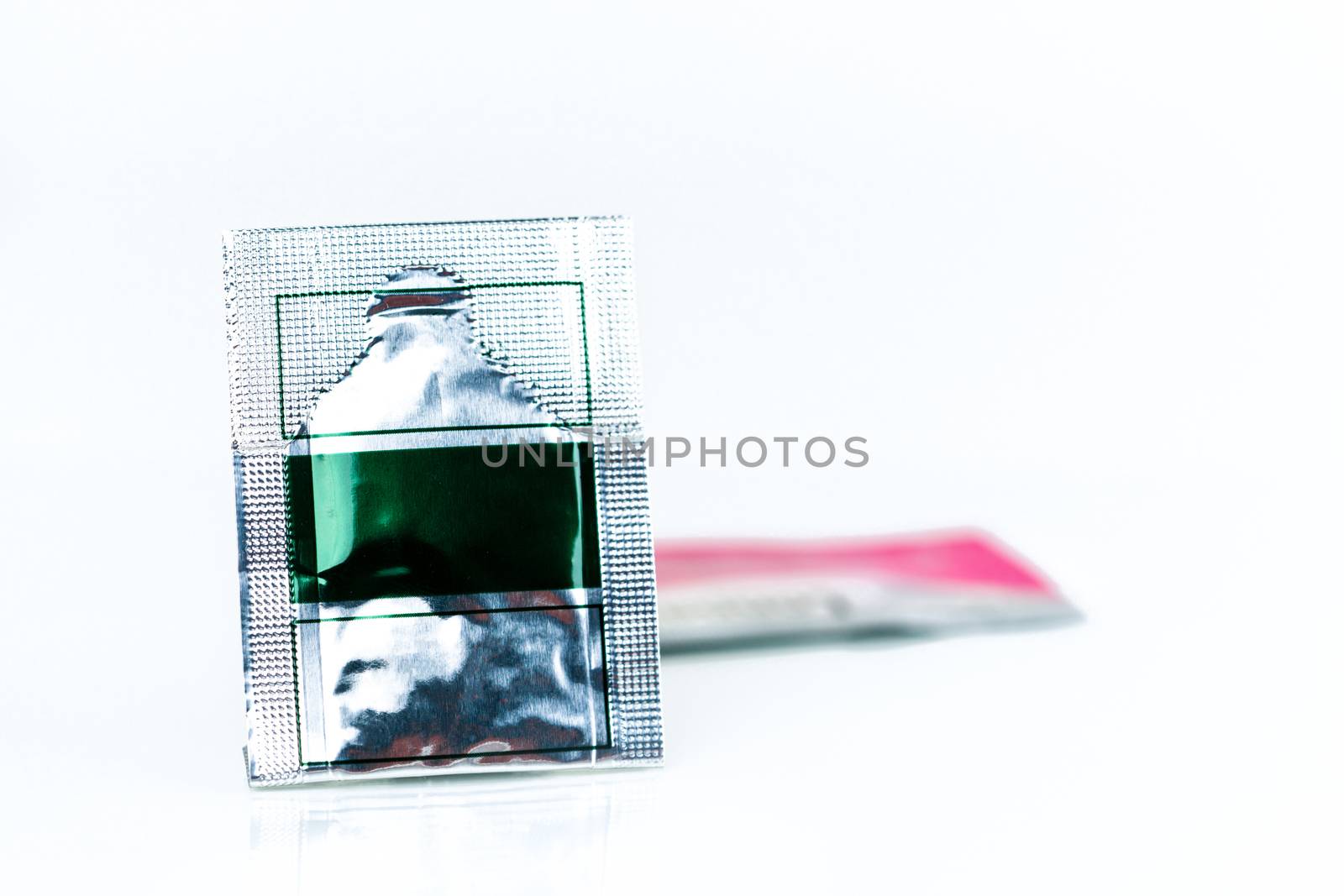 Mild steroid oral paste in aluminium foil sachet on blur background of sachets. Anti-inflammatory for oral mucous membrane, relief oral tenderness, pain, and ulceration. Aphthous ulcer or mouth ulcers by Fahroni