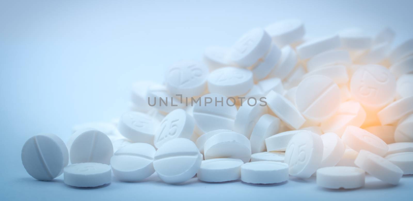 Pile of white tablets pill containing "2.5".  Terbutaline sulfate 2.5 mg use for relief of bronchospasm in asthma patient. Bronchodilator drug. Pharmaceutical industry concept. Global Healthcare.