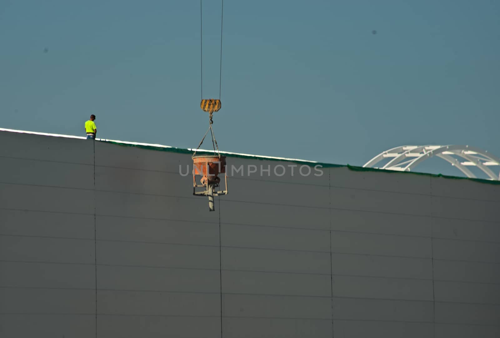 NOVI SAD, SERBIA - July 14th: Worker supervising crane lifting weight by sheriffkule