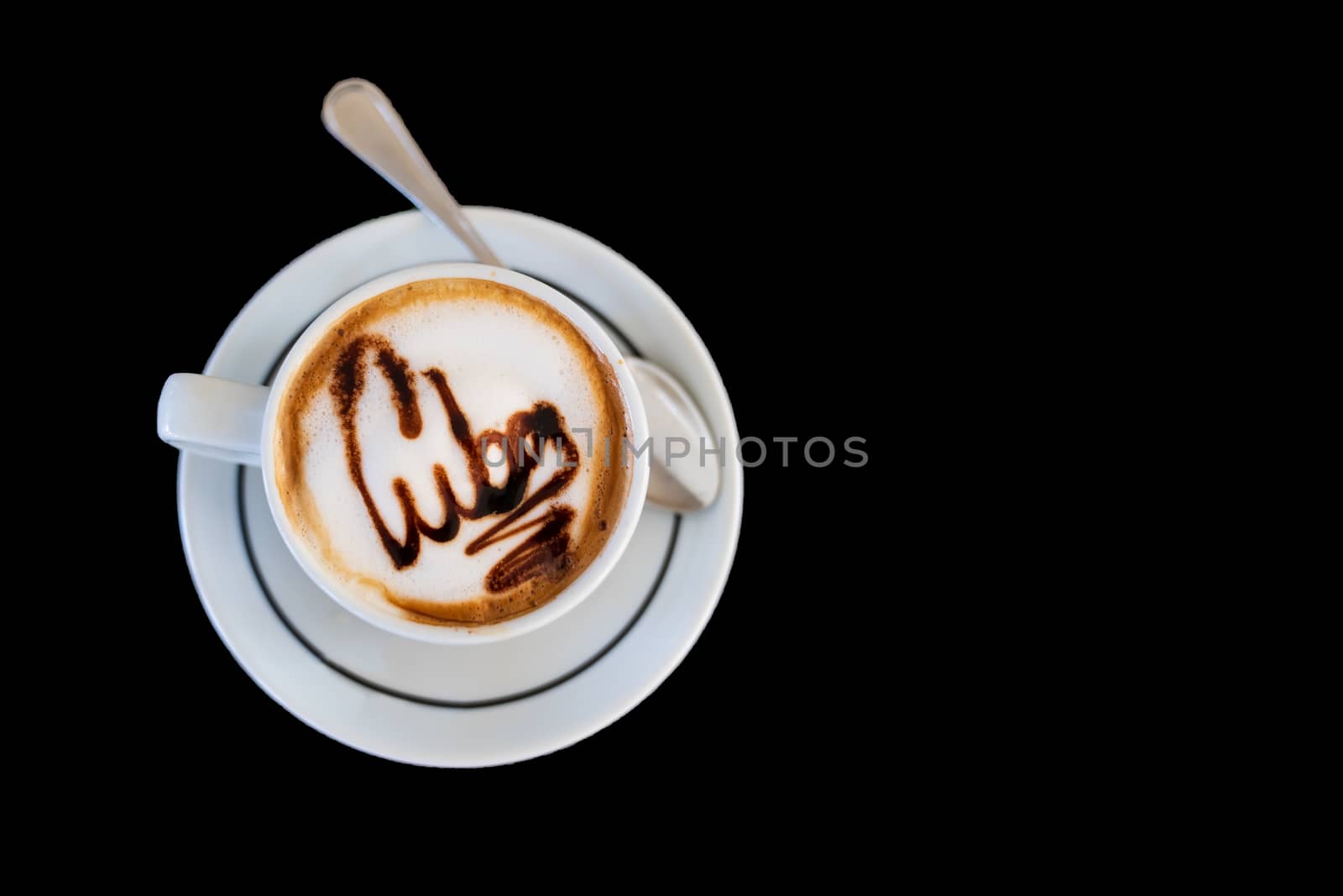 Cappuccino on a cup with foam and above the foam the inscription Cuba on a black background