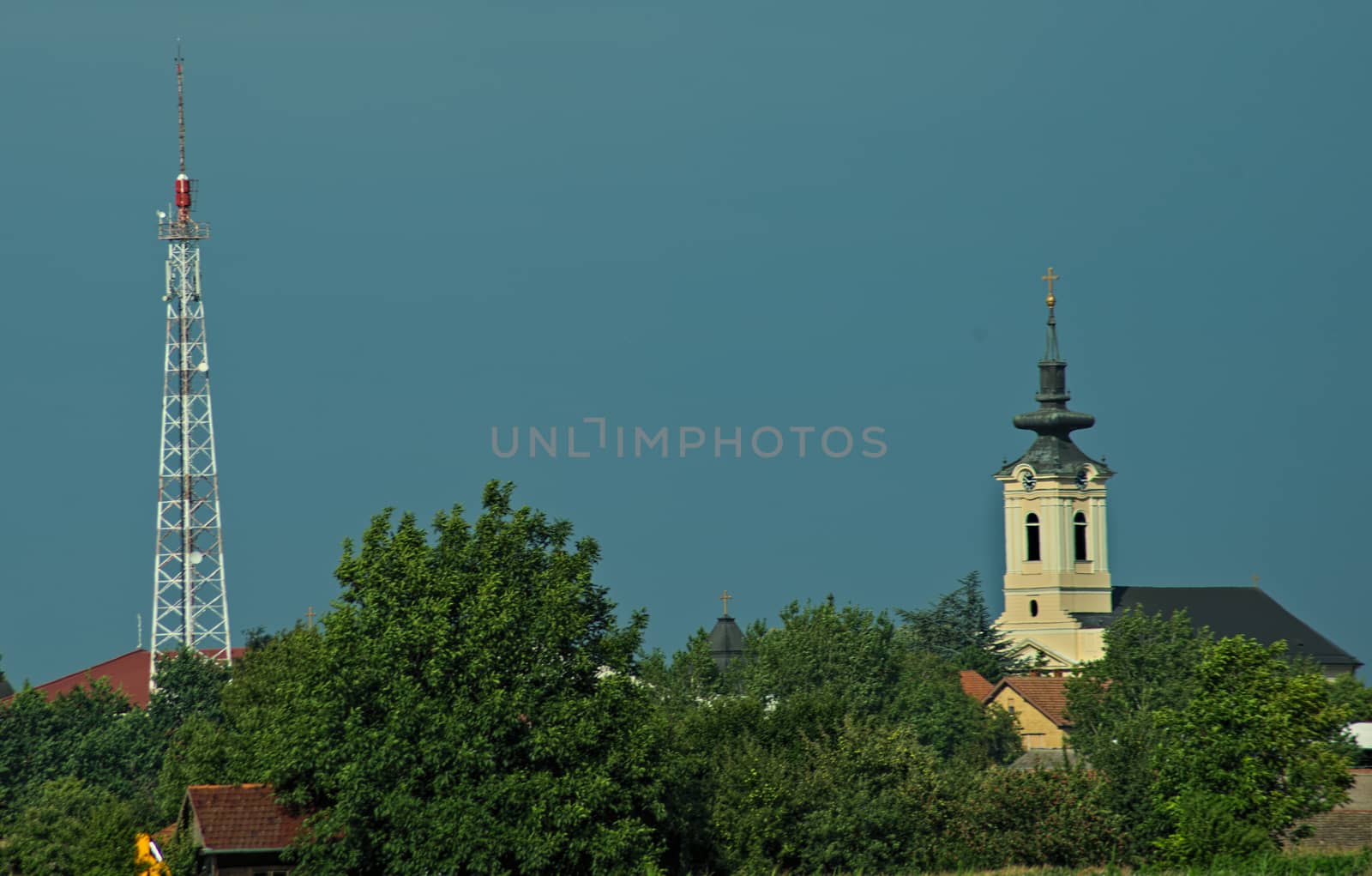 Radio tower and church tower spiking above trees by sheriffkule
