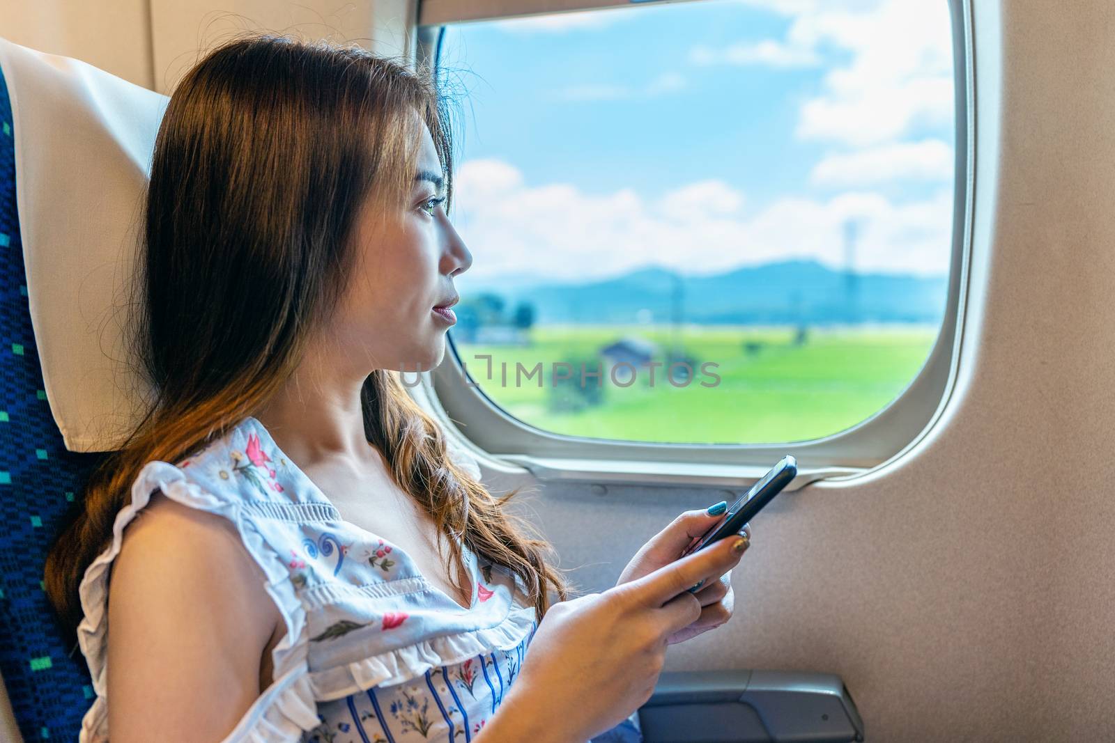 woman using smartphone in the train.