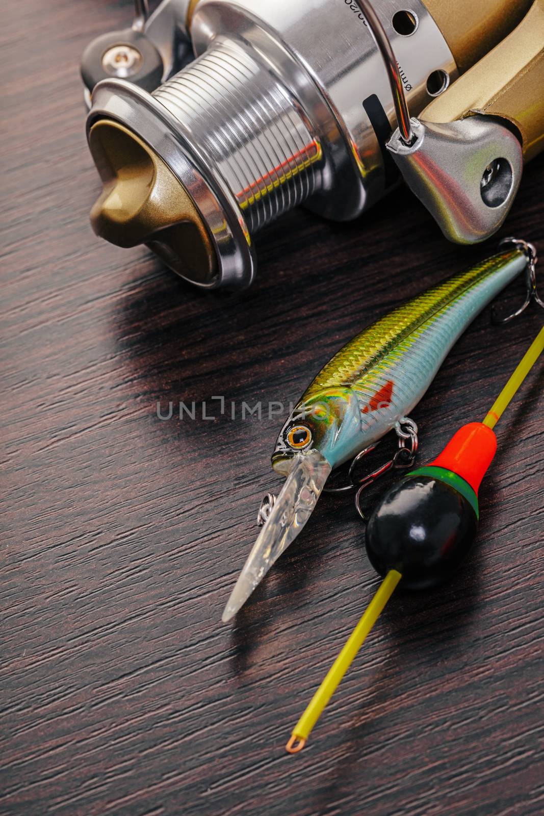 Tackle for fishing rods closeup on wooden background