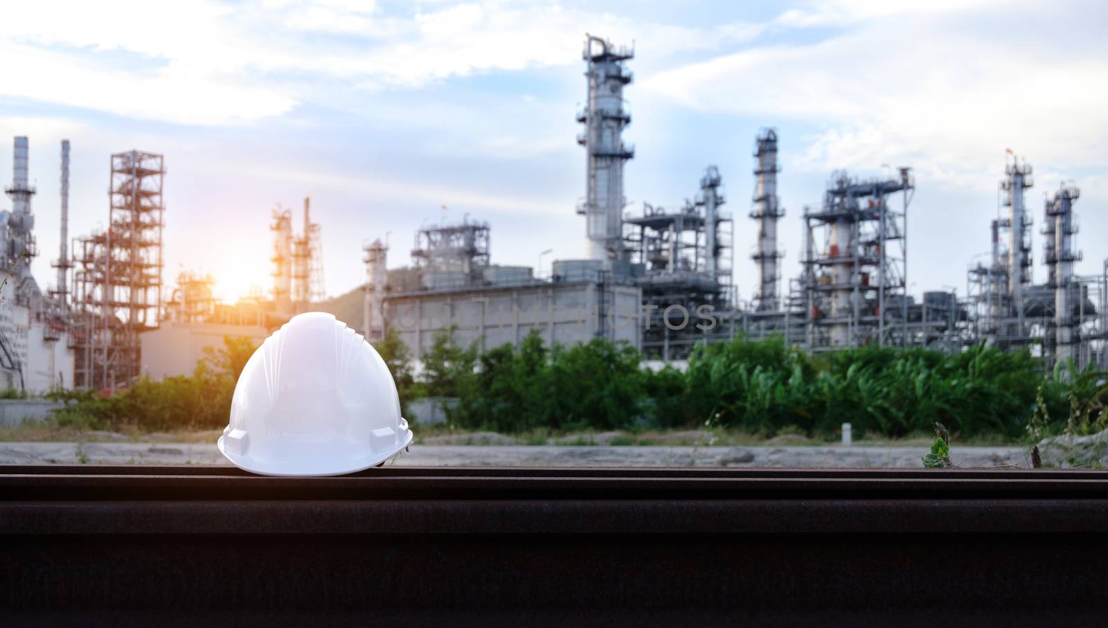 Helmet construction on the metal bar with industrial background.