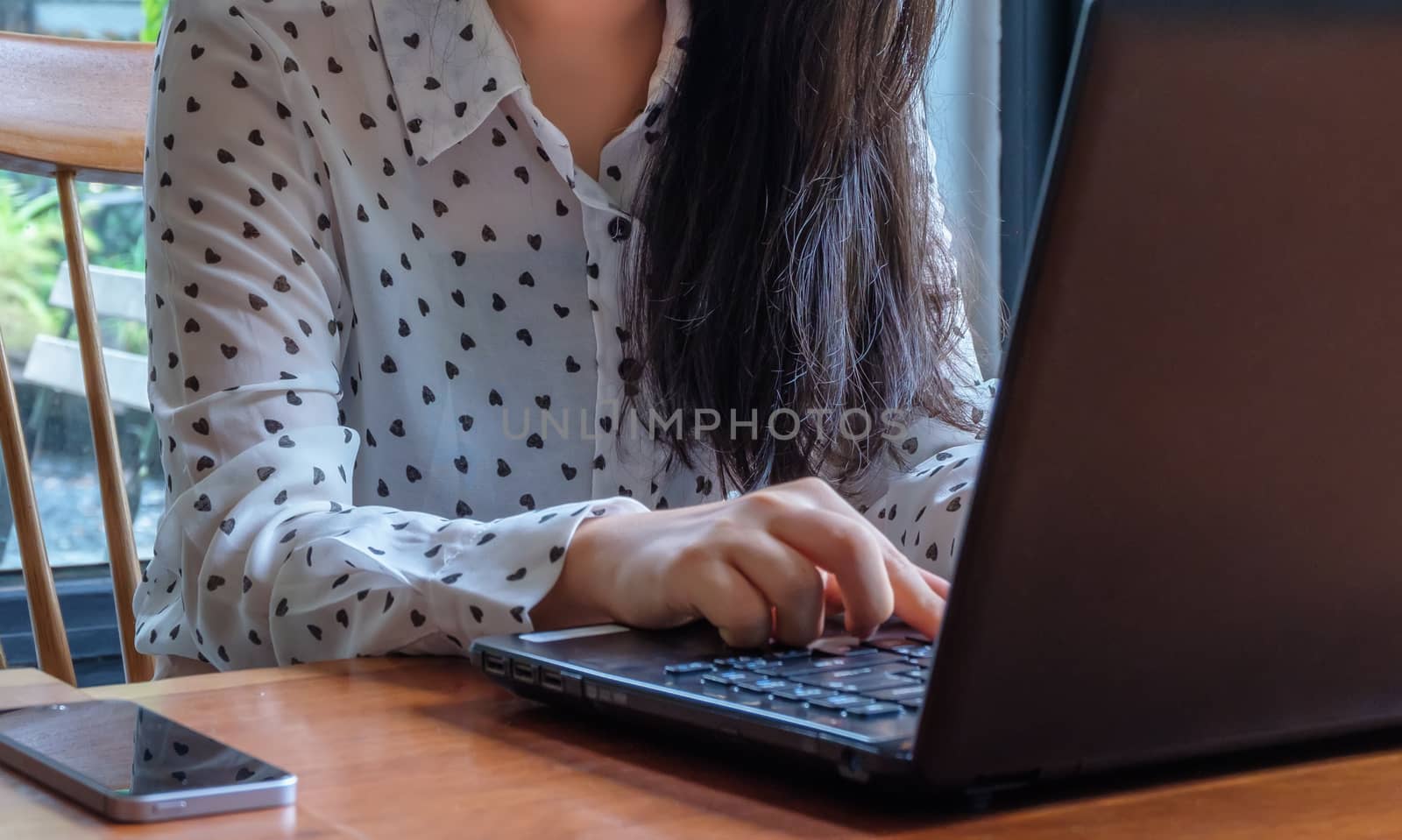 Hand of businesswoman using using laptop in office.