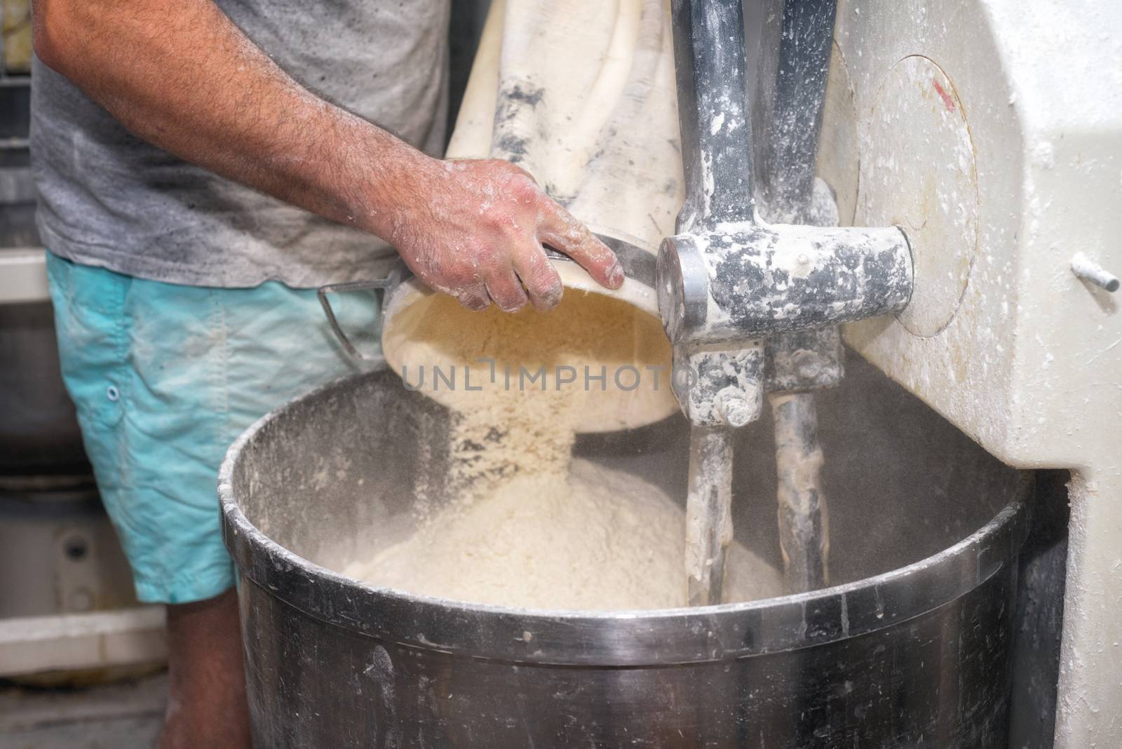 Loading flour into an industrial bakery dough mixer. by HERRAEZ