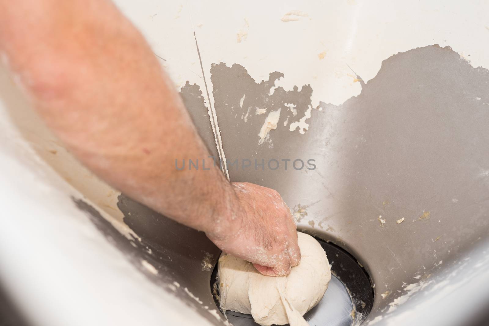 Baker hands kneading bread dough  by HERRAEZ