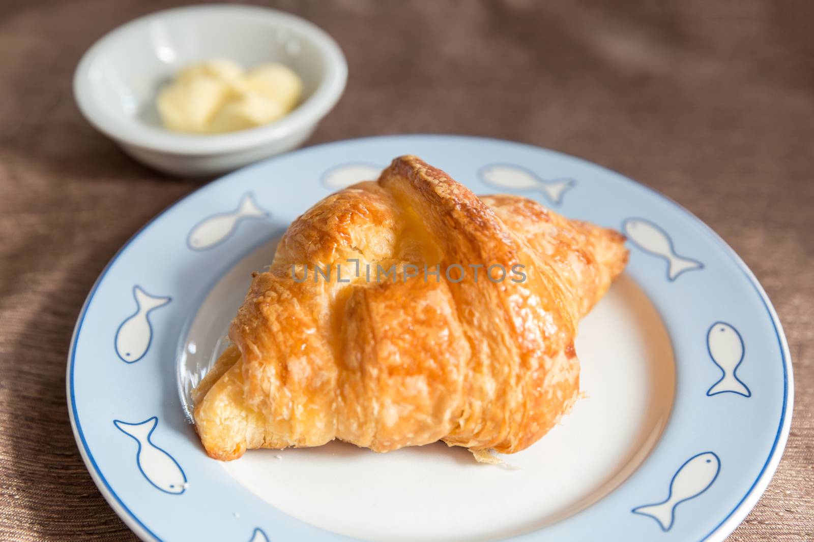 Fresh croissant and tasty butter for breakfast