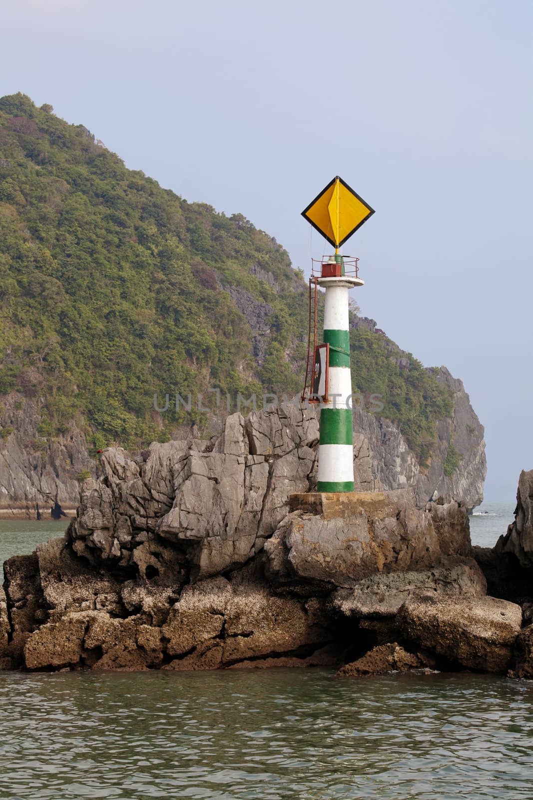 Small lighthouse on a rock in Ha Long bay, Vietnam