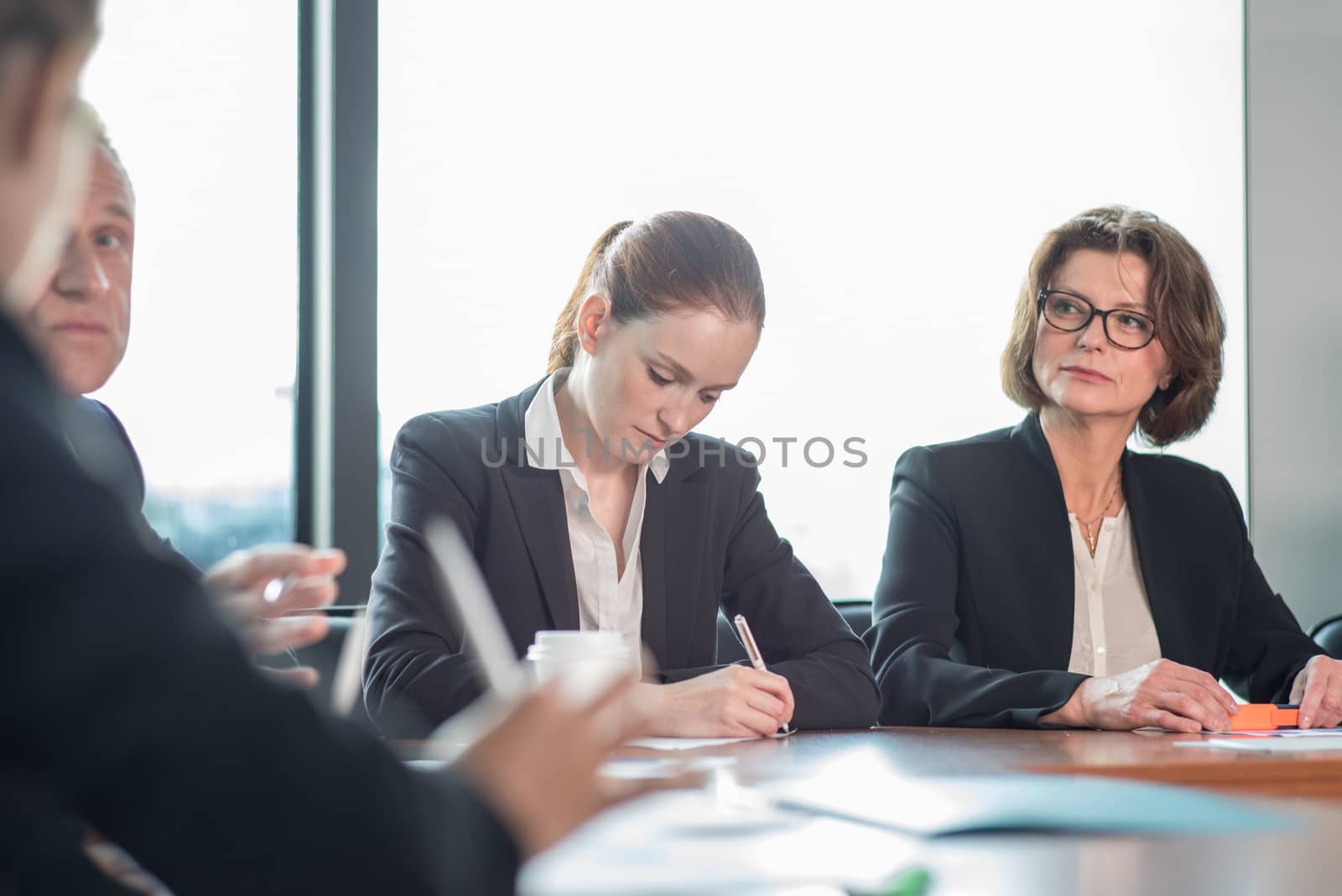 Image of business partners discussing documents and ideas at meeting