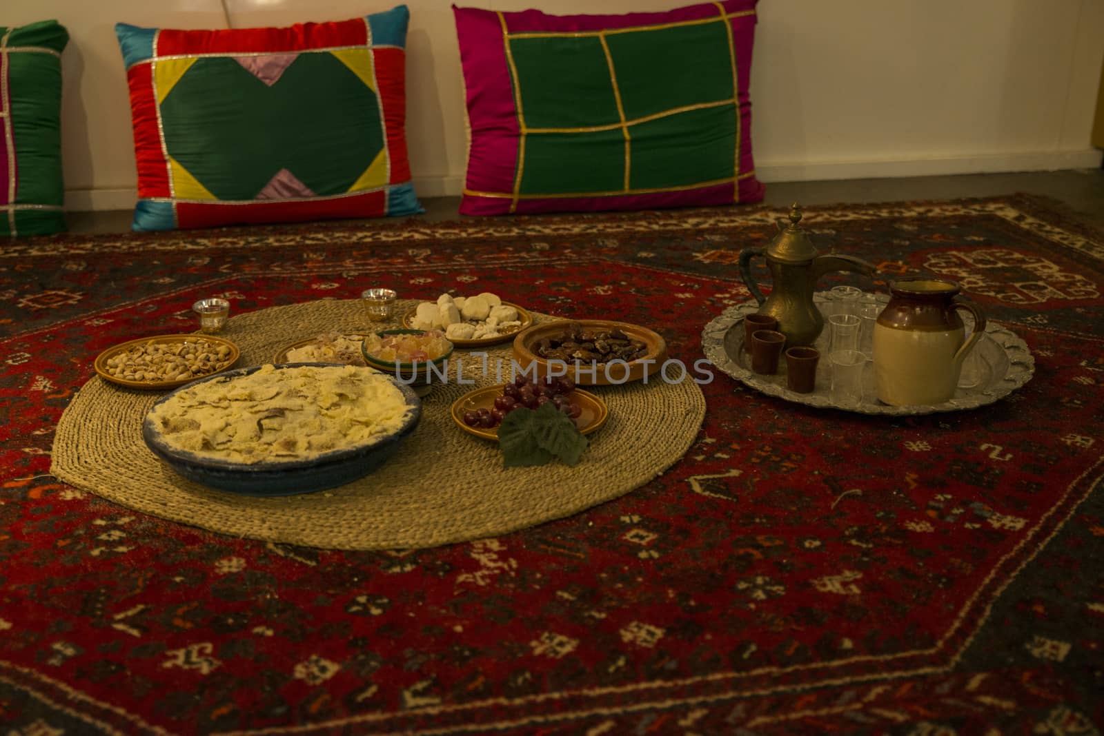 spcial made moslim food for the end of the ramadan, with sweet and grapes and thee to drink, on a carpet on the floor