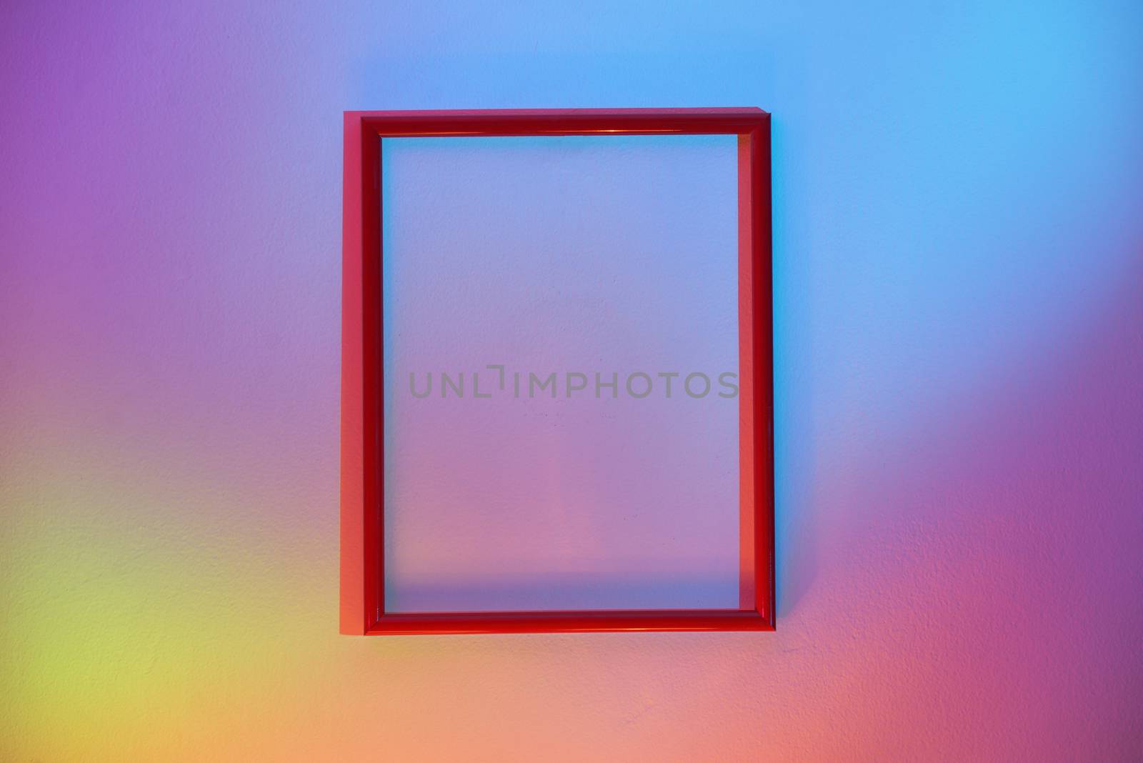 Empty Frame Hanging On A Colorful Wall by mady70