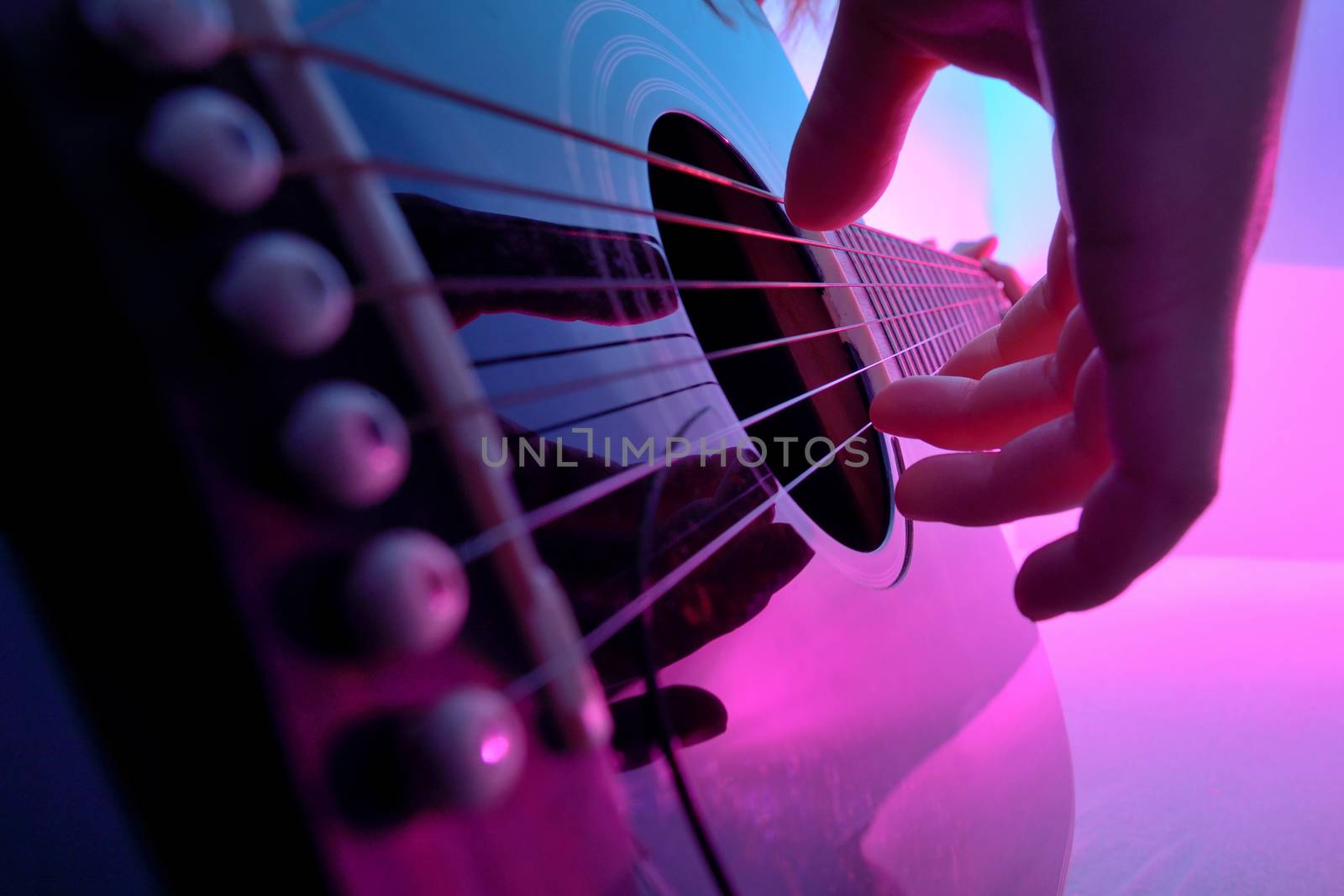 Closeup of an acoustic guitar played by a girl by mady70
