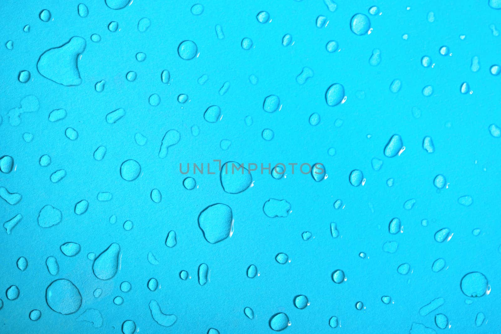 Water drops on a blue glass background