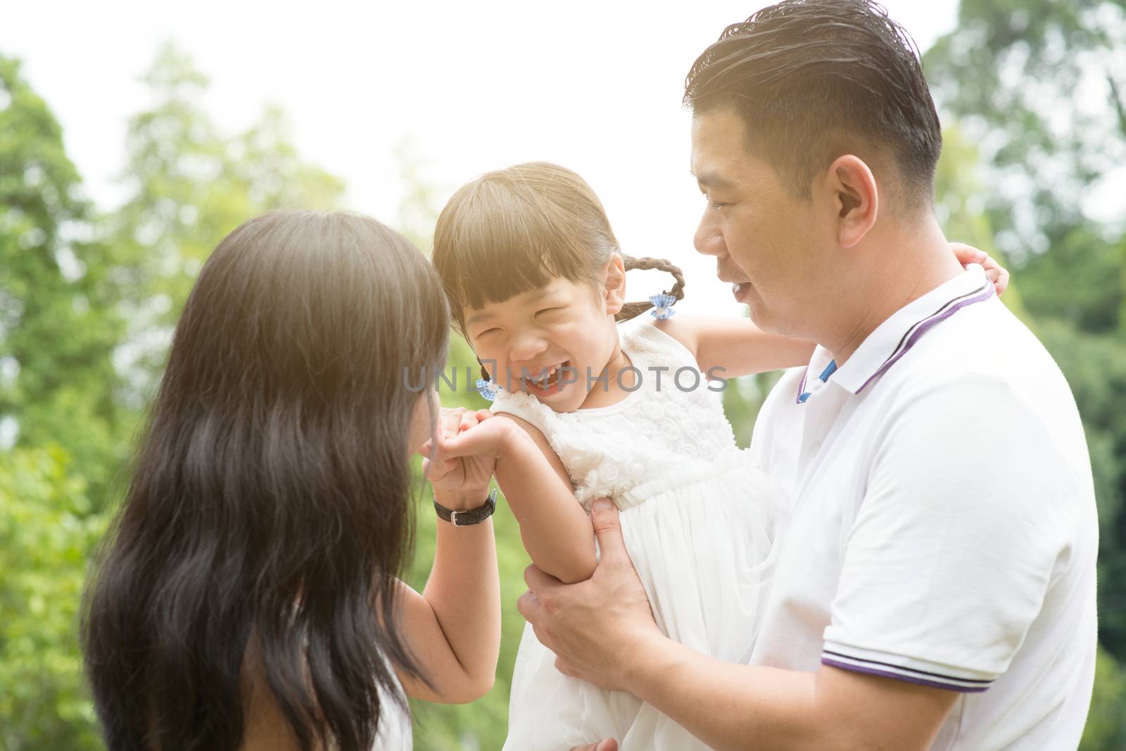 Happy family playing at outdoors by szefei