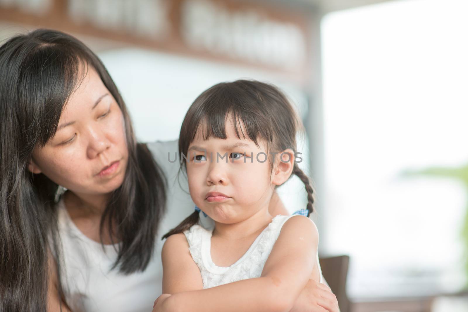 Candid shoot of people in cafeteria. Little girl with various face expression. Asian family outdoor lifestyle with natural light.