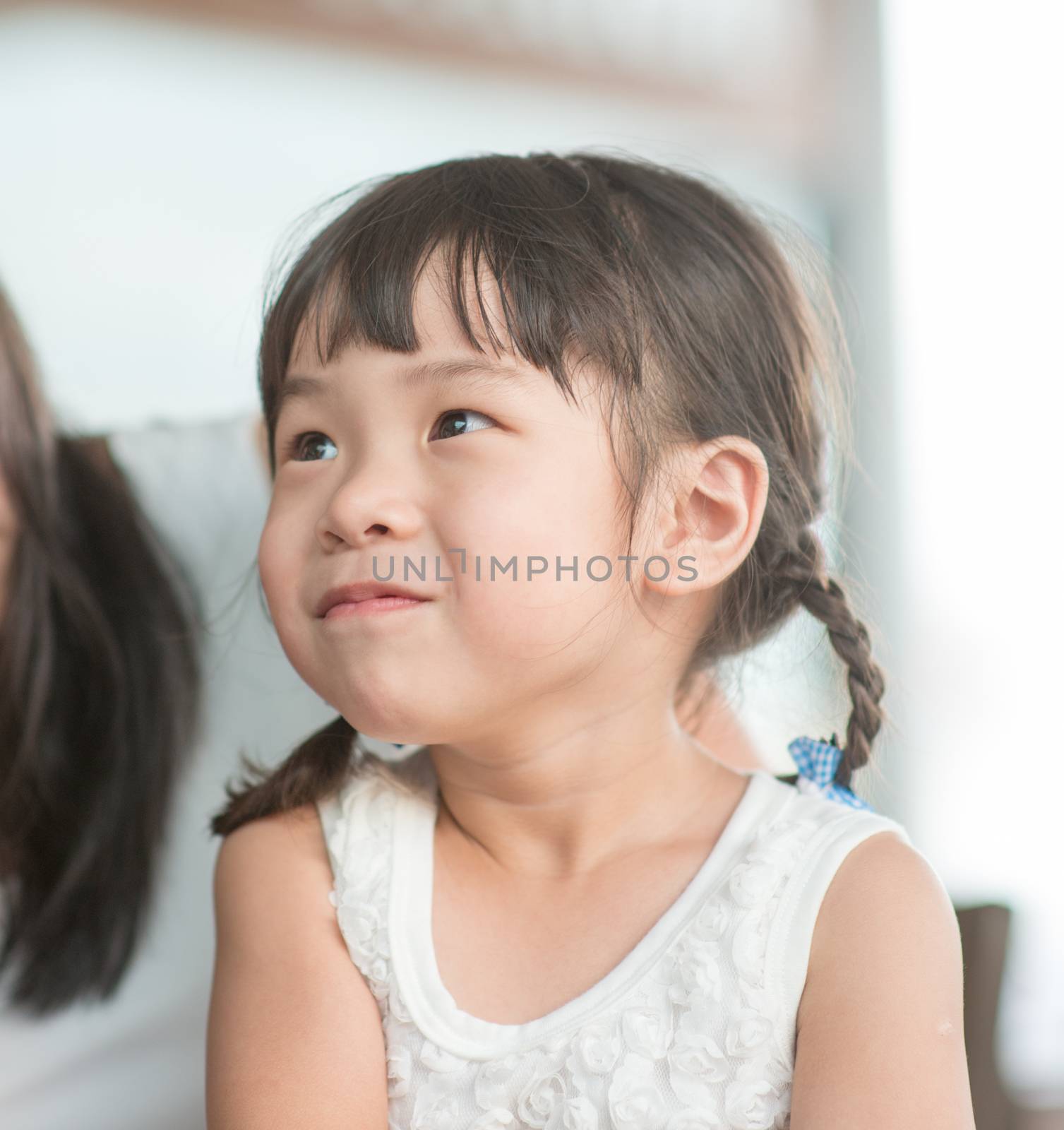 Candid shoot of people in cafeteria. Little girl with various face expression. Asian family outdoor lifestyle with natural light.