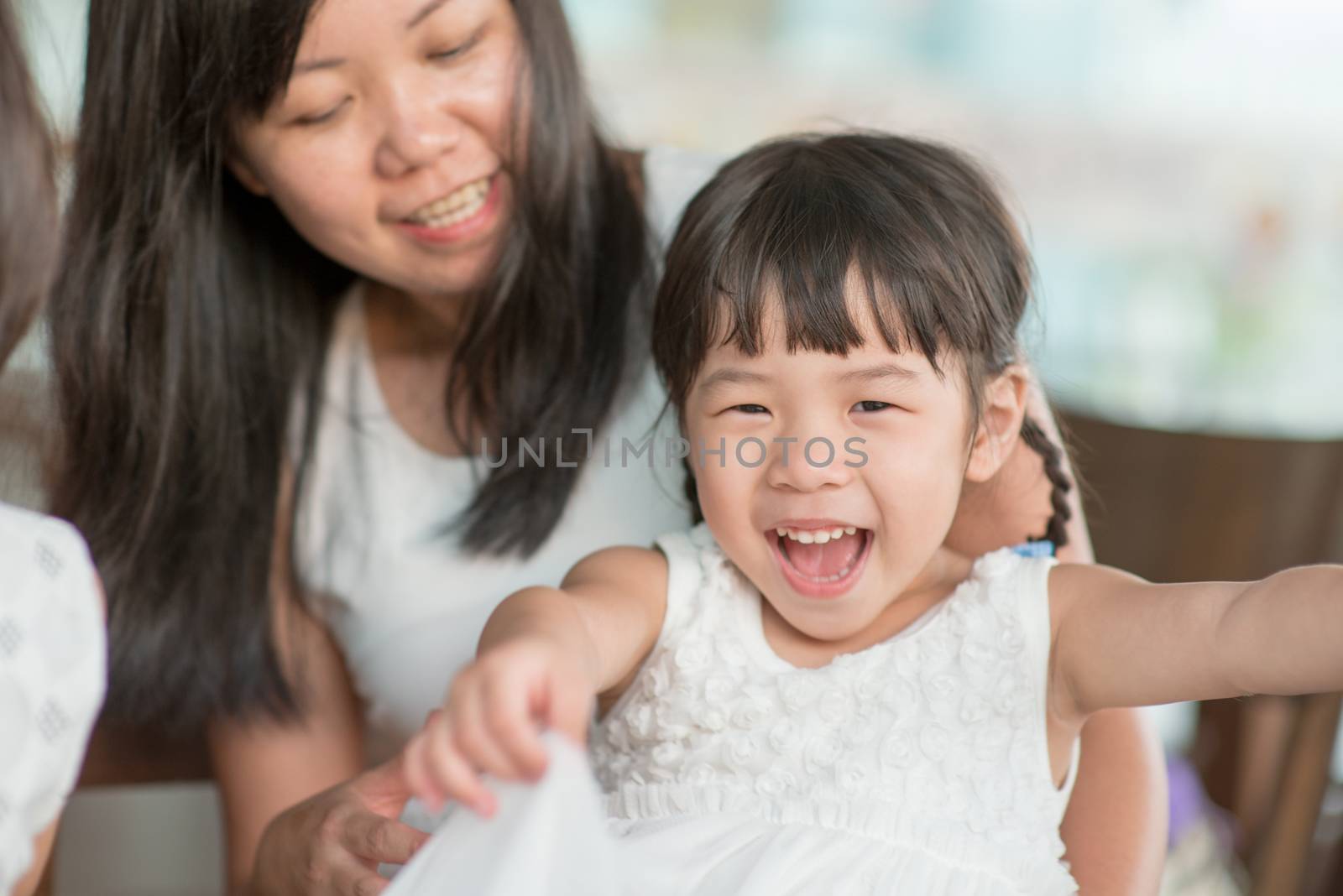 Candid shoot of people in cafeteria. Little girl with various face expression. Asian family outdoor lifestyle with natural light.