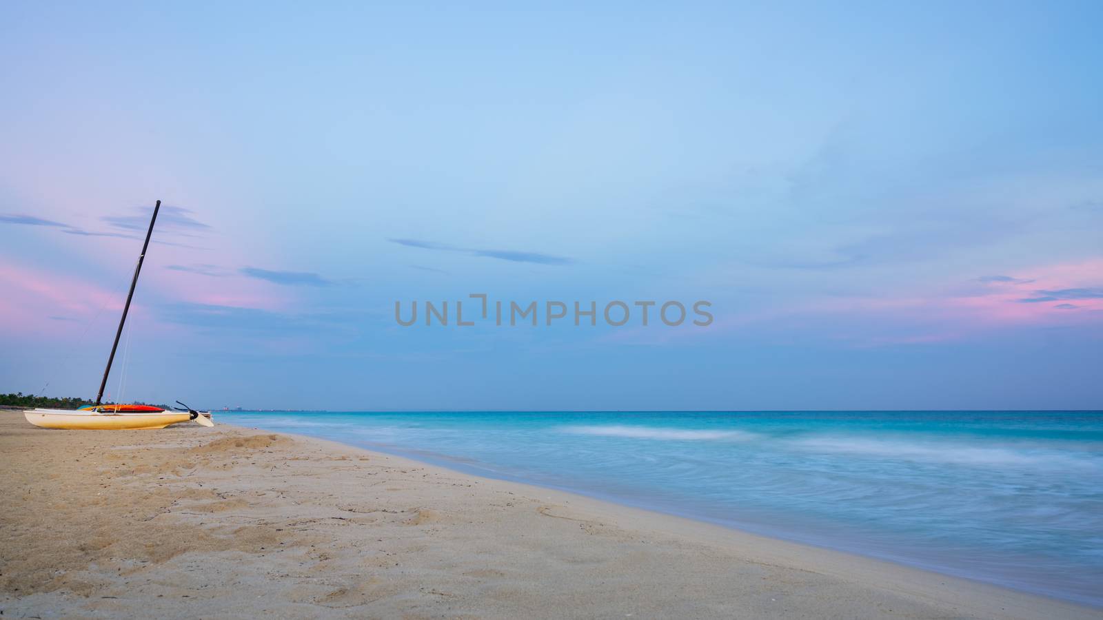 Catamaran  at sunset on the Beach by Robertobinetti70