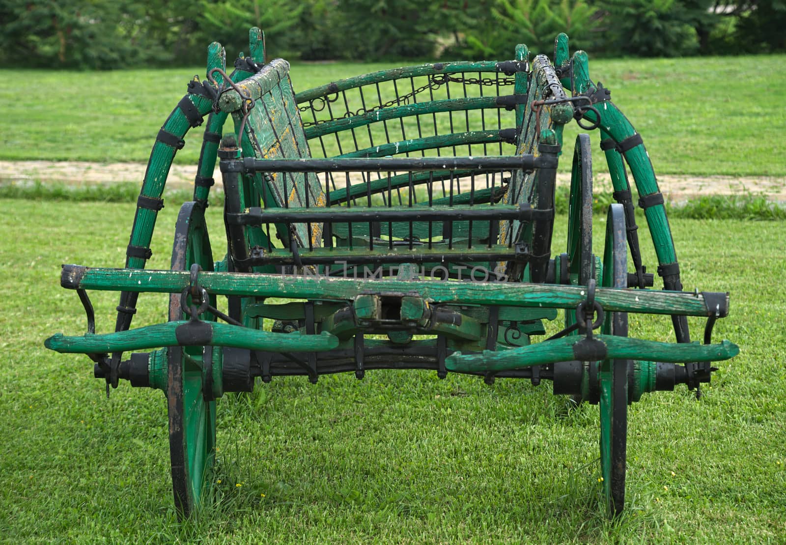 Old rustic vintage carriage in yard, front view