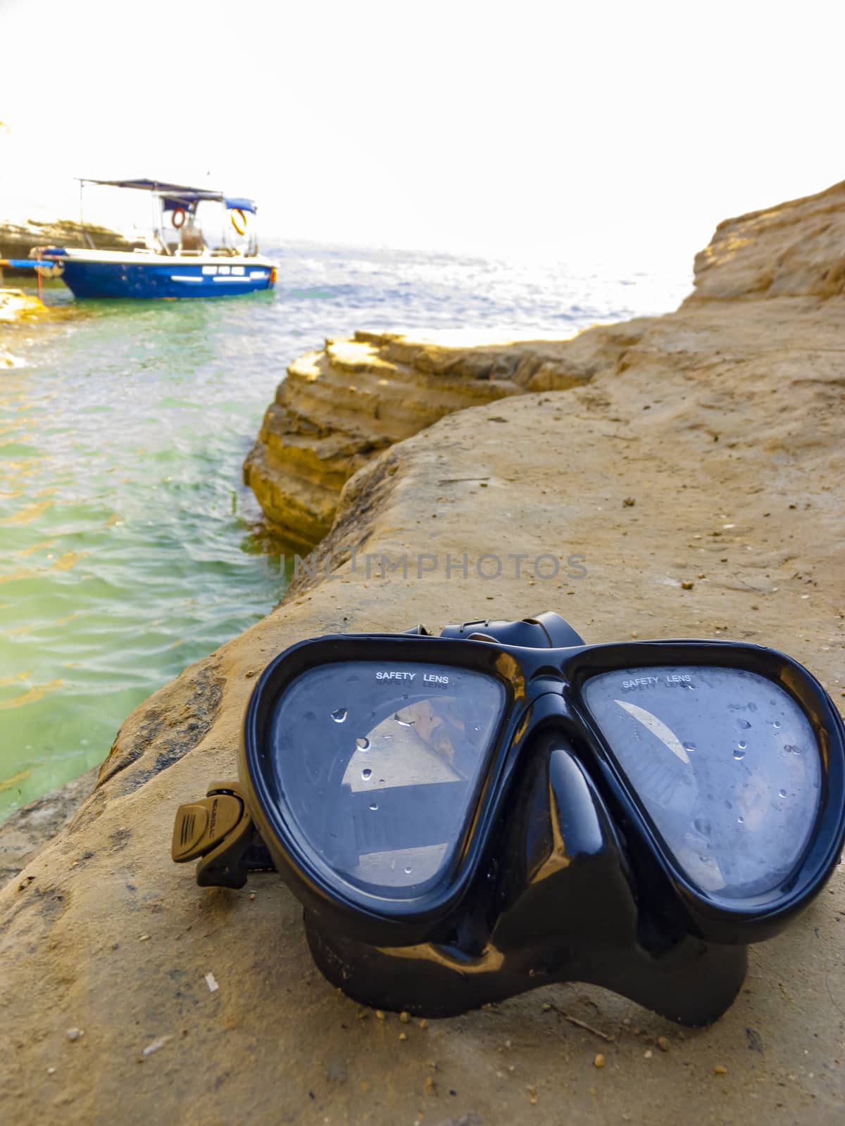 Diving mask for scuba diving on the rock near the sea by ankarb