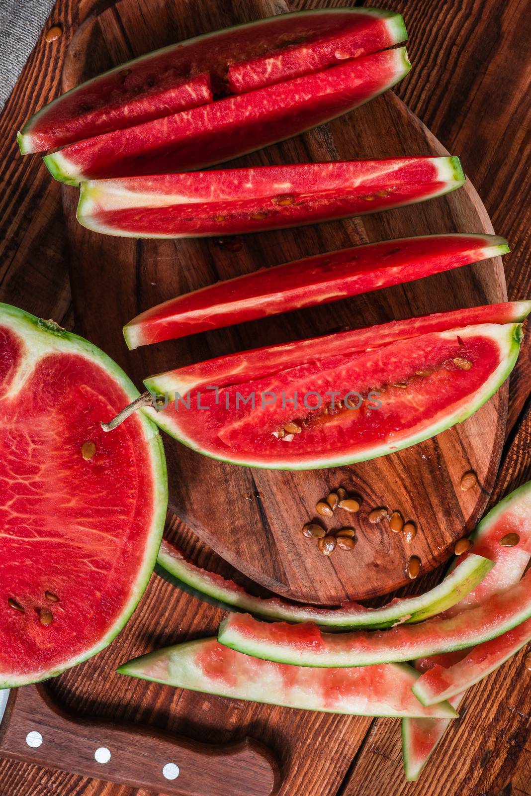 Watermelon slices and peels lying on the board by Seva_blsv