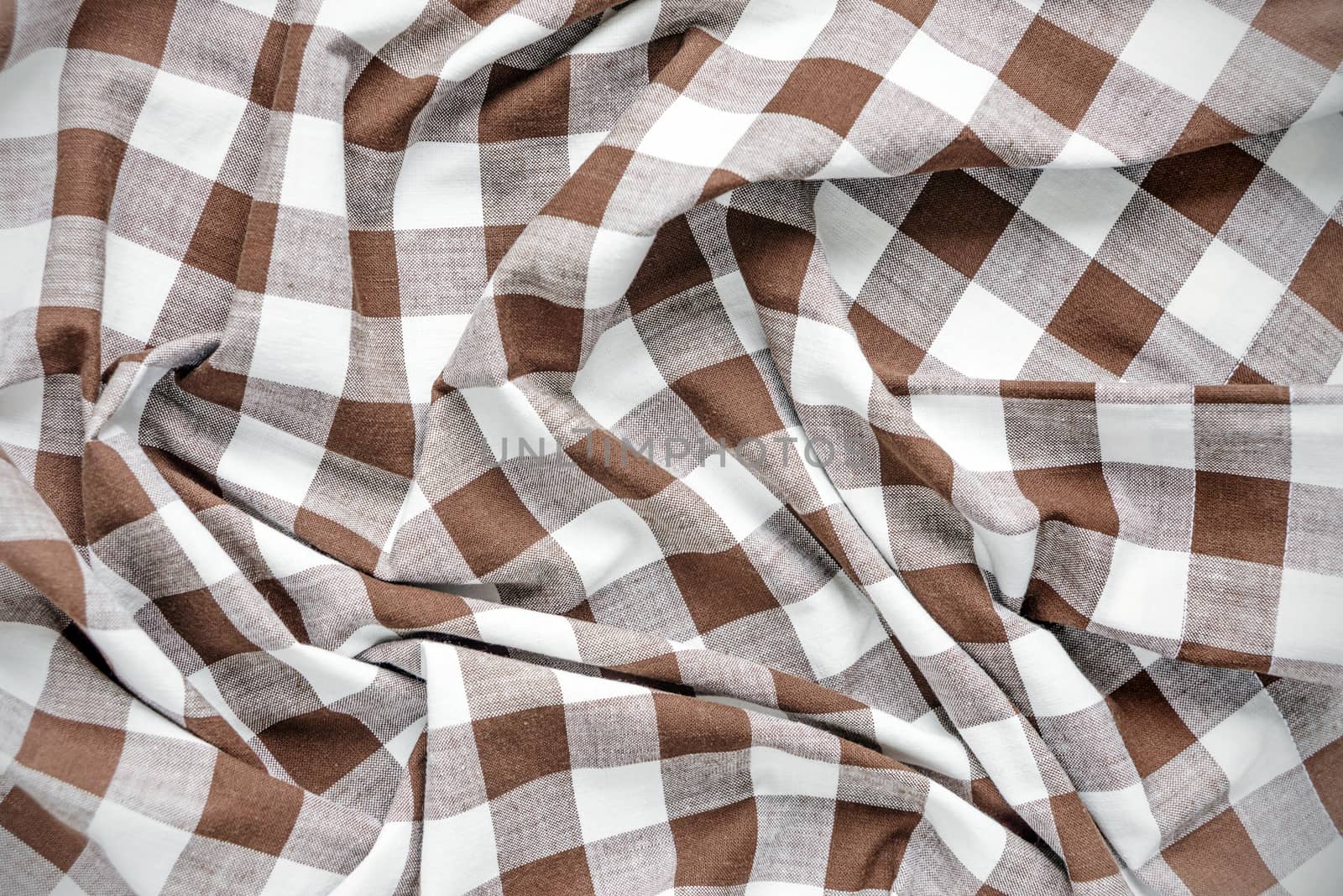 Creasy white and brown checked cotton fabric closeup