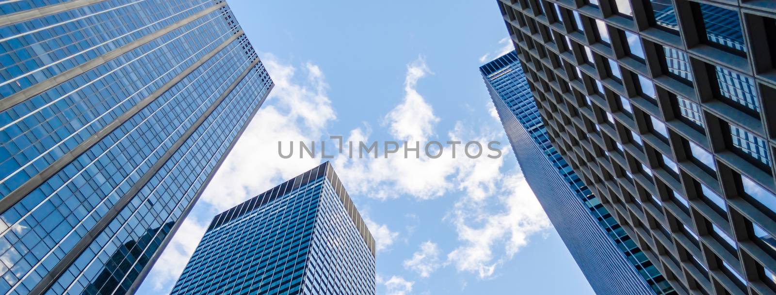 Bottom view of modern skyscrapers in business district of Manhattan, New York, USA. Concept for business, finance, real estate