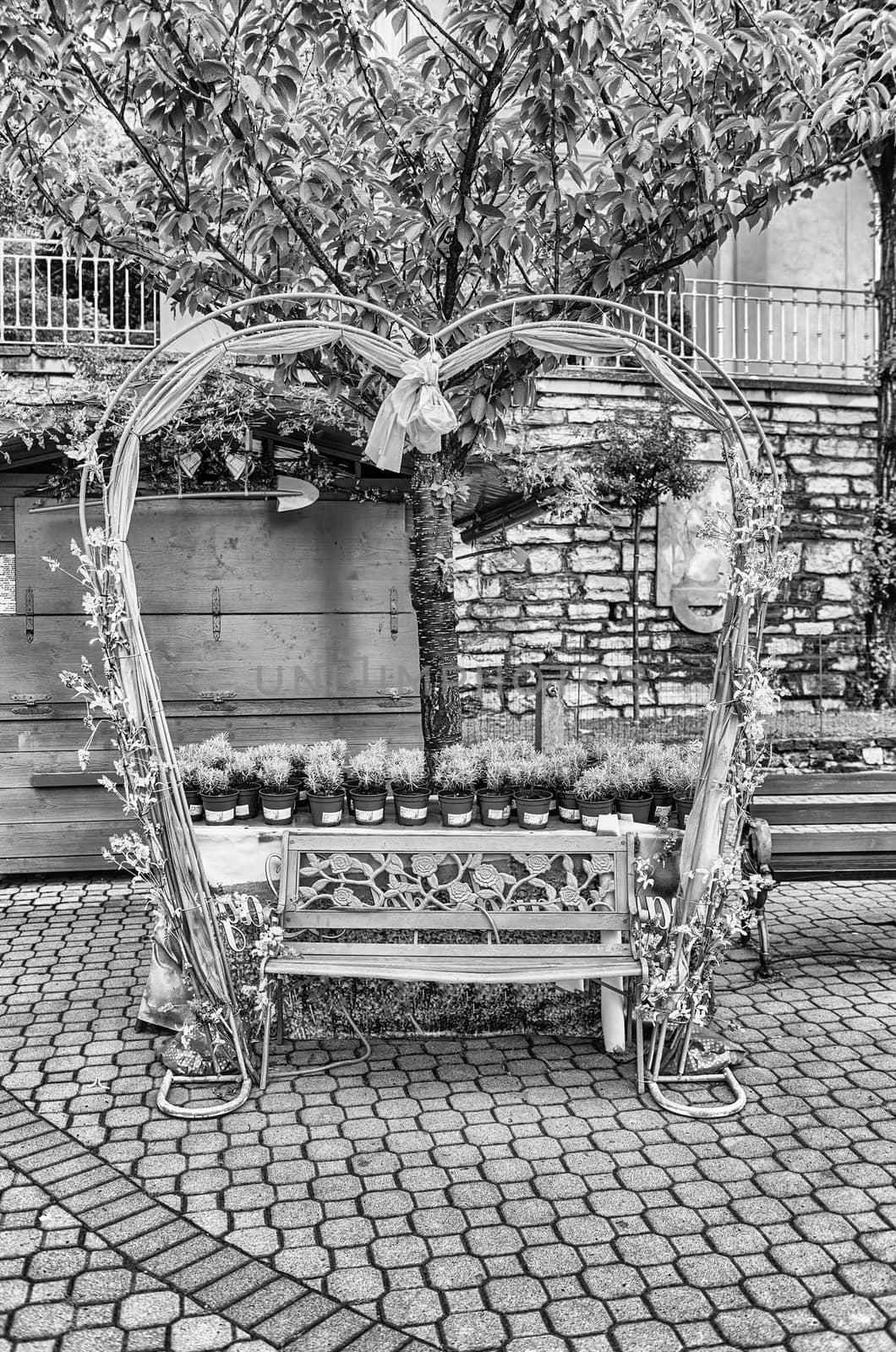 Scenic heart-shaped bench decorated with flowers and laces by marcorubino