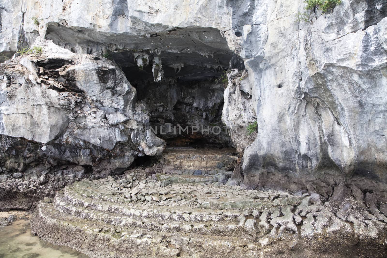 Entrance in a sea cave at Ha Long bay, Vietnam