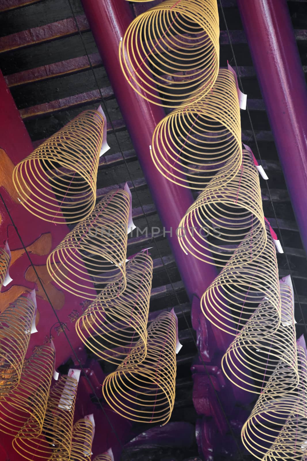 Spiral incense burning hanging from the ceiling in Vietnamese temple