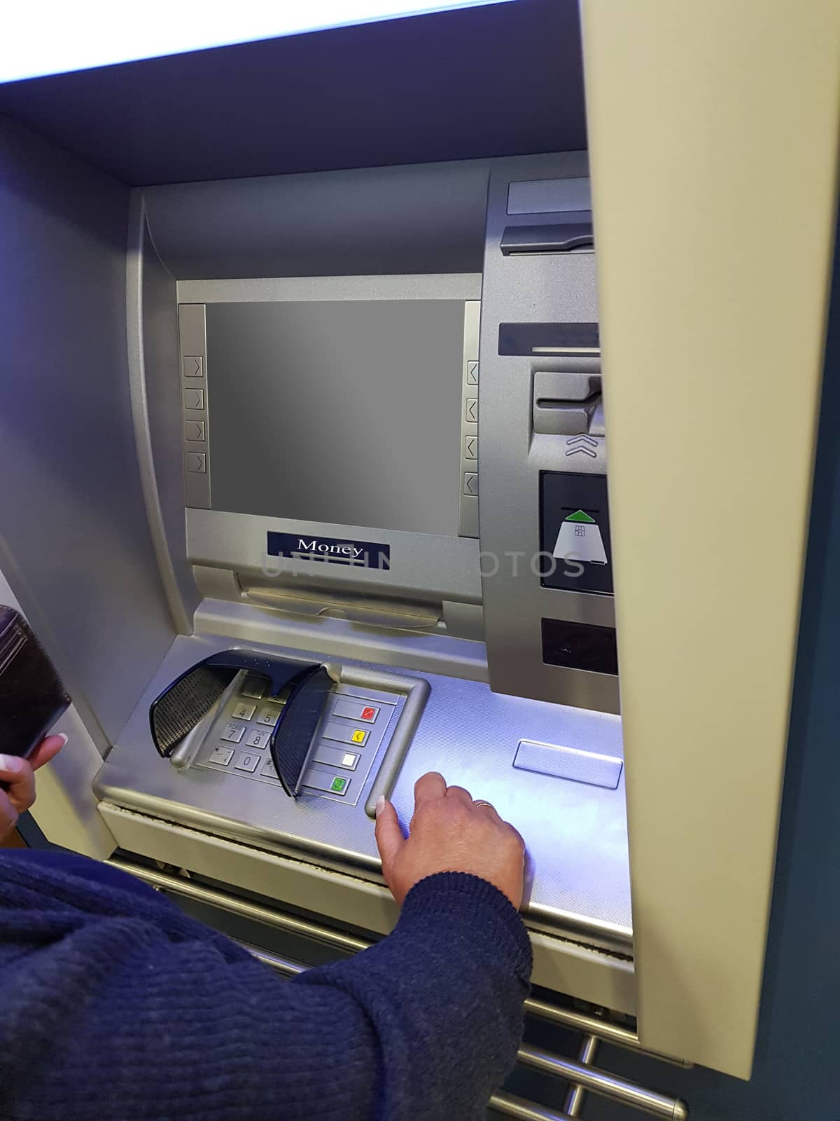 Woman at an ATM cash machine with leeen screen