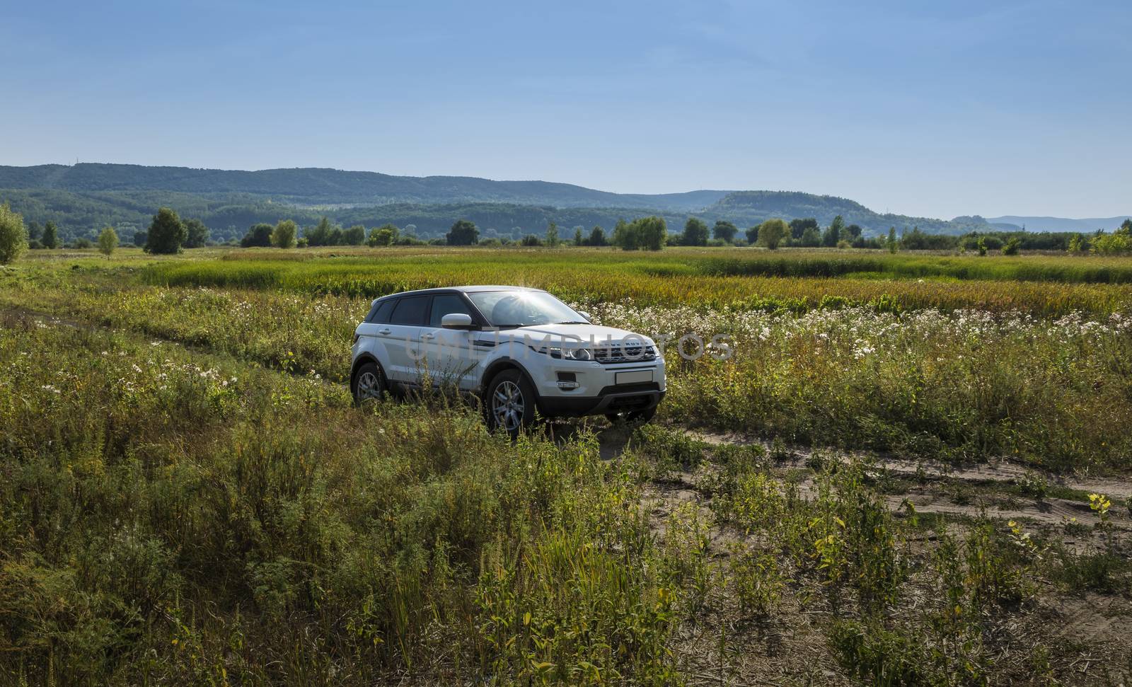 Car Land Rover Range Rover is in the field on a Sunny autumn day near the city of Samara, Russia. August 1, 2018 by butenkow