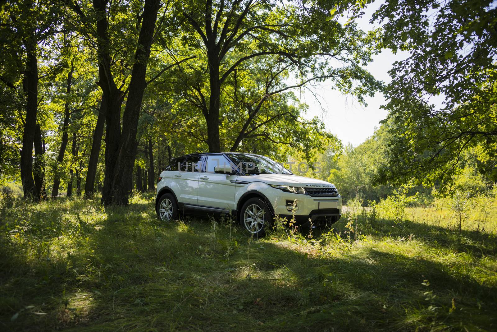 Car Land Rover Range Rover in summer Sunny weather in the summer landscape of the Samara region, Russia. August 21, 2018.