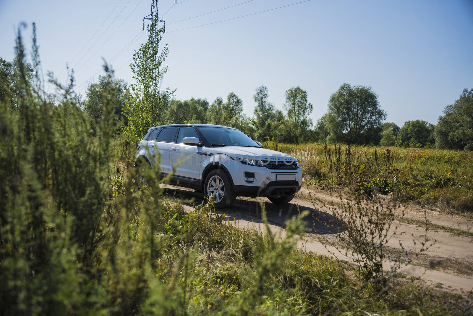 Car Land Rover Range Rover in summer Sunny weather in the summer landscape of the Samara region, Russia. August 21, 2018 by butenkow