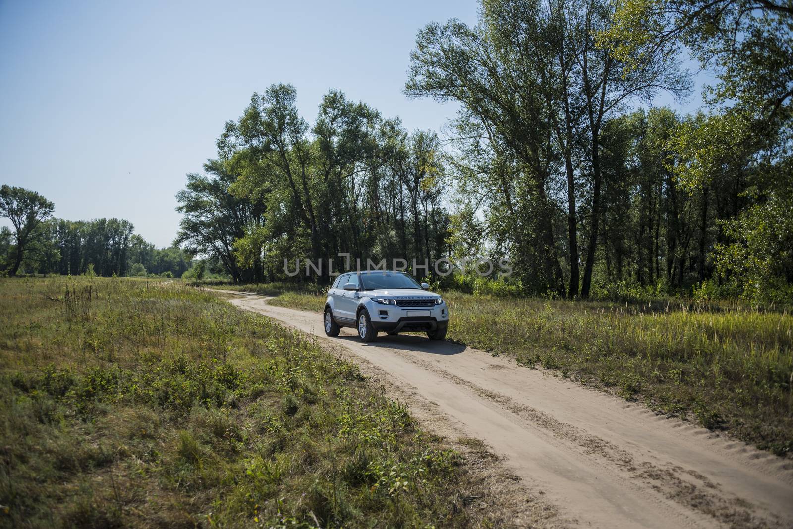 Car Land Rover Range Rover in summer Sunny weather in the summer landscape of the Samara region, Russia. August 21, 2018 by butenkow