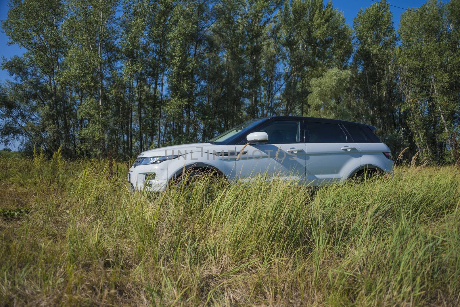 Car Land Rover Range Rover in summer Sunny weather in the summer landscape of the Samara region, Russia. August 21, 2018.