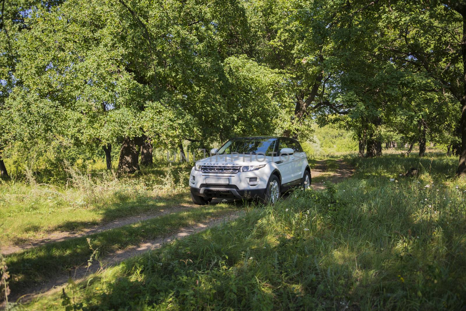 Car Land Rover Range Rover in summer Sunny weather in the summer landscape of the Samara region, Russia. August 21, 2018.