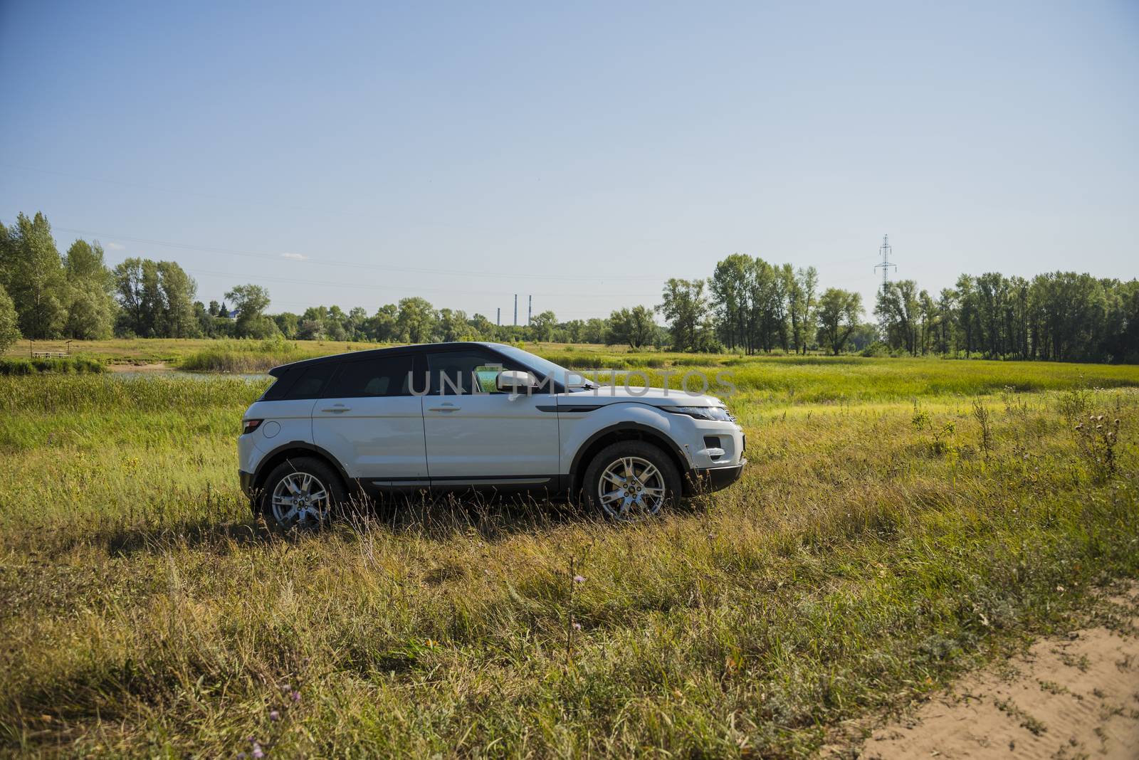 Car Land Rover Range Rover in summer Sunny weather in the summer landscape of the Samara region, Russia. August 21, 2018.