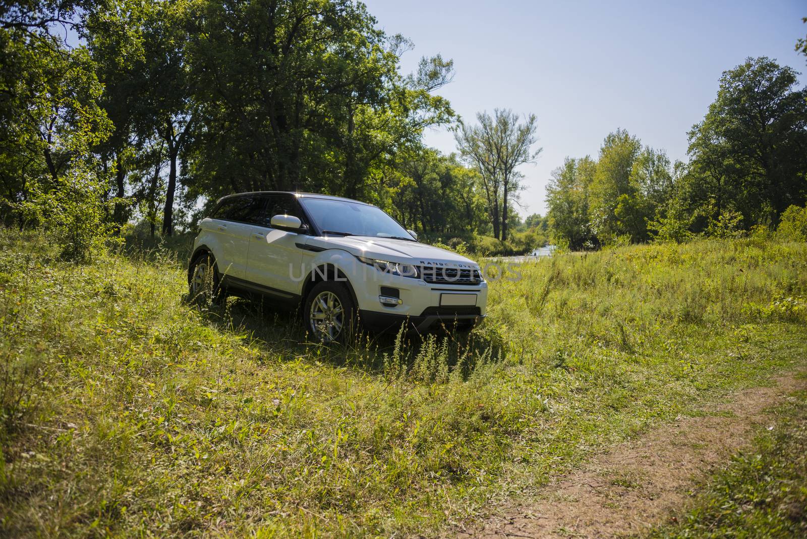 Car Land Rover Range Rover in summer Sunny weather in the summer landscape of the Samara region, Russia. August 21, 2018.