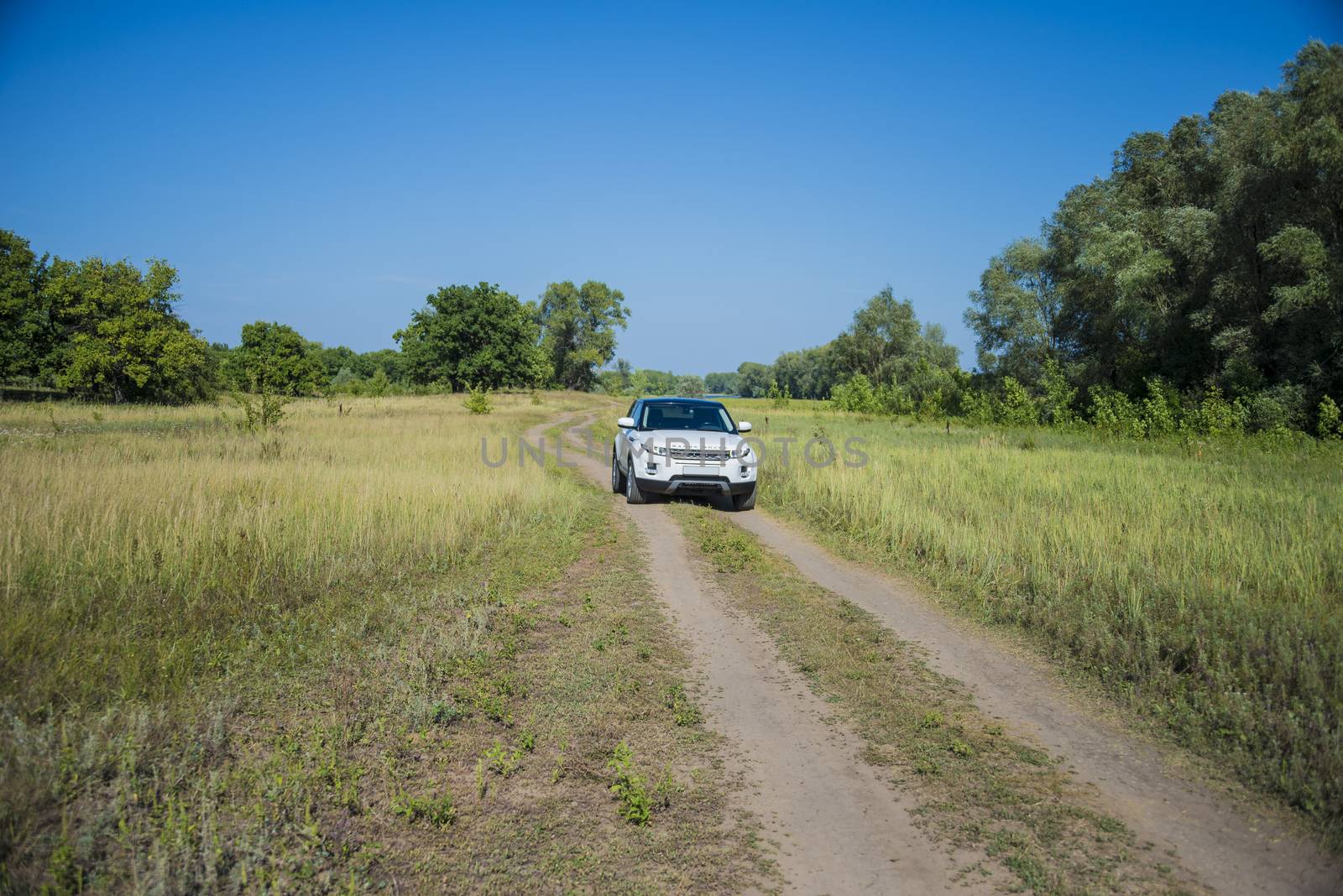 Car Land Rover Range Rover in summer Sunny weather in the summer landscape of the Samara region, Russia. August 21, 2018 by butenkow